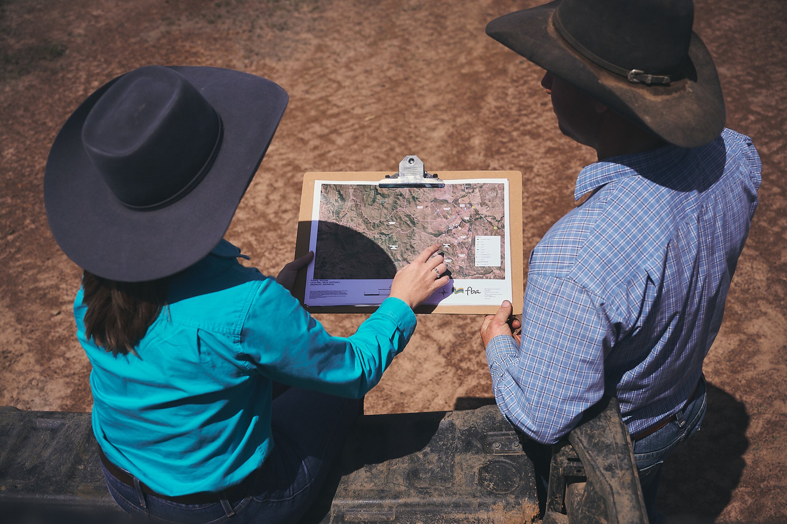 An FBA staff member looking at a property map with a land manager