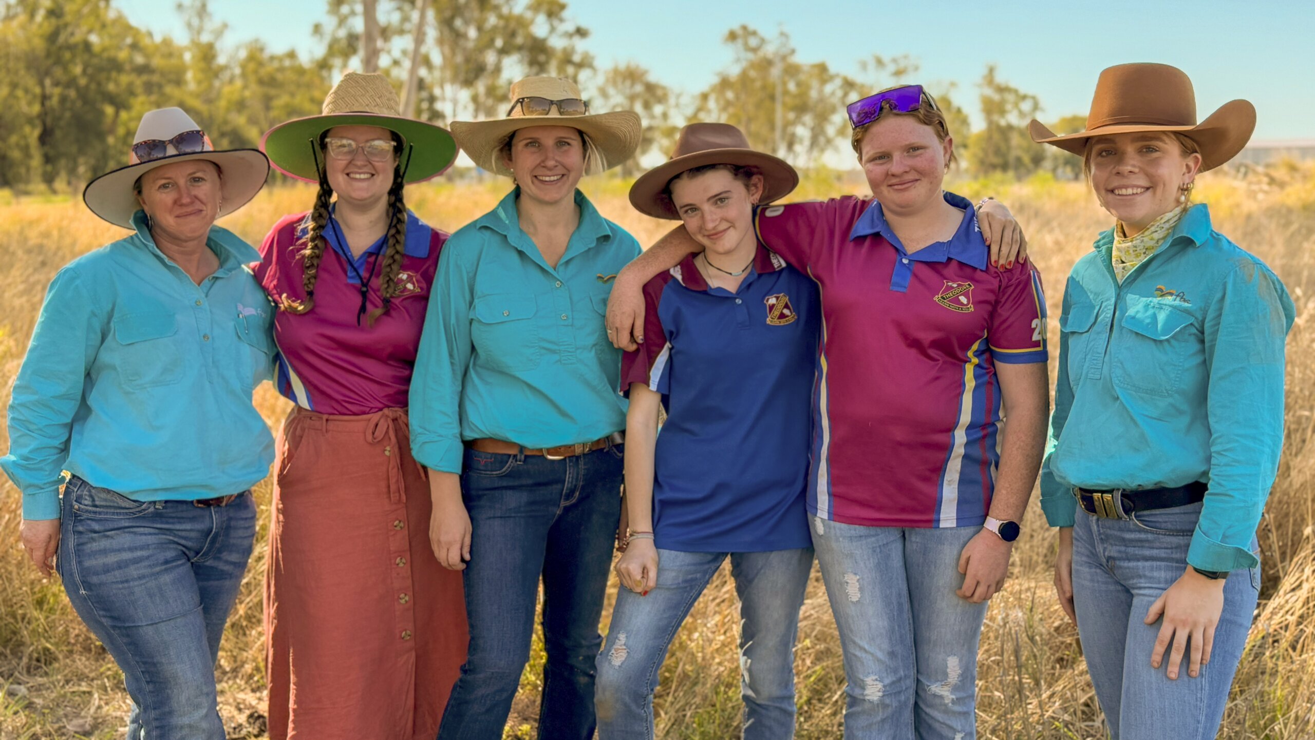 FBA staff members with Theodore State School member smiling at the camera
