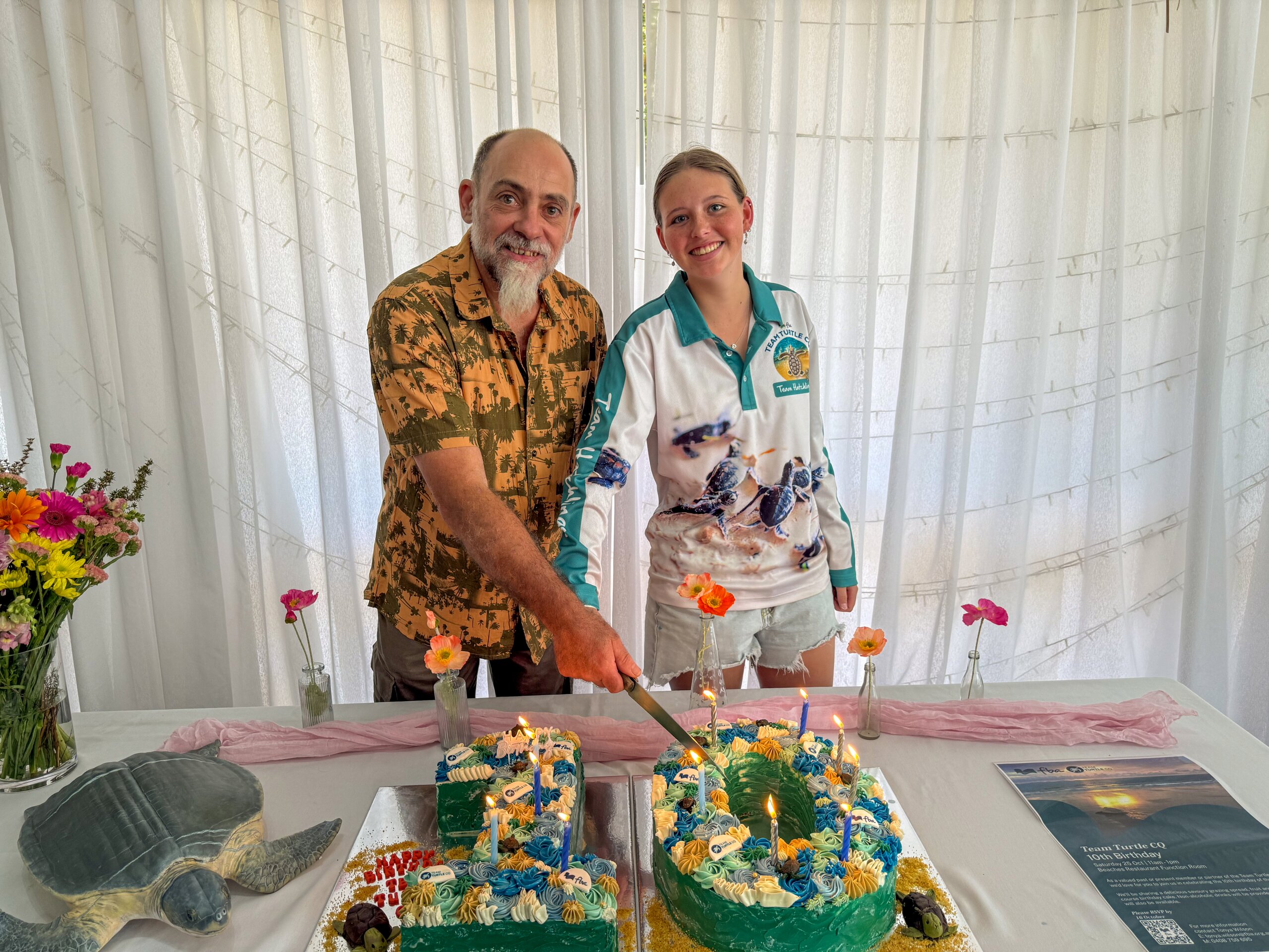 Two members of FBA Team Turtle CQ cutting a cake