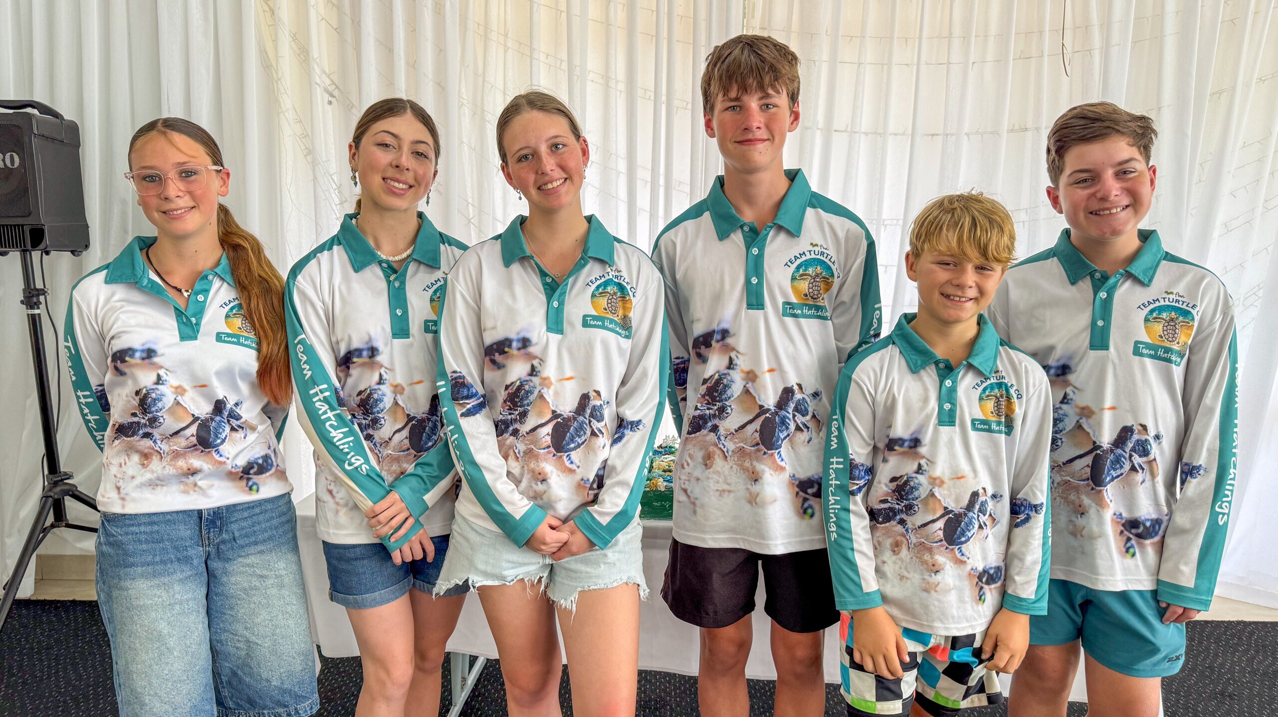 Young volunteers of FBA Team Turtle CQ smiling at the camera