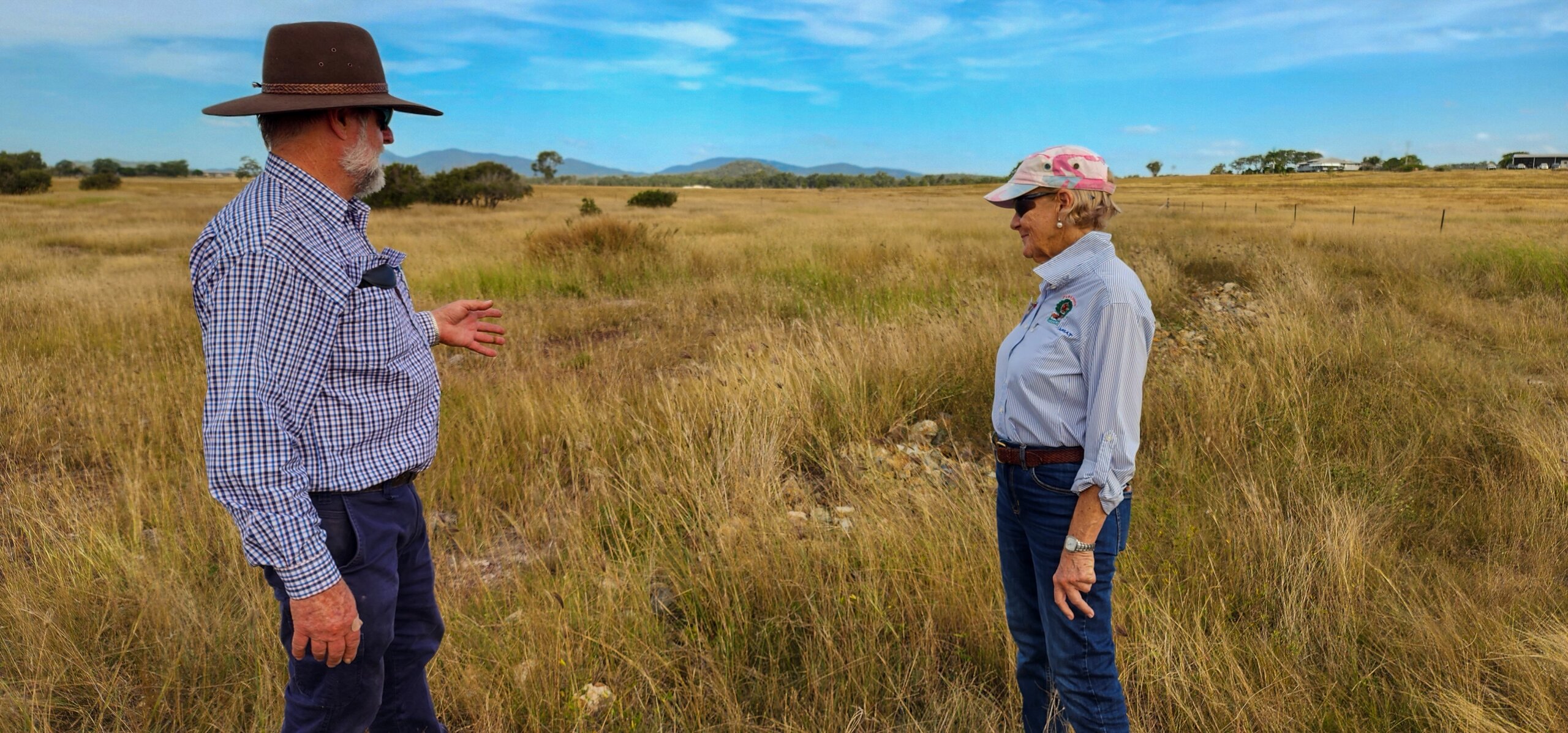 John Day and Kaye Black standing in a field at Roots of Resilience Workshop