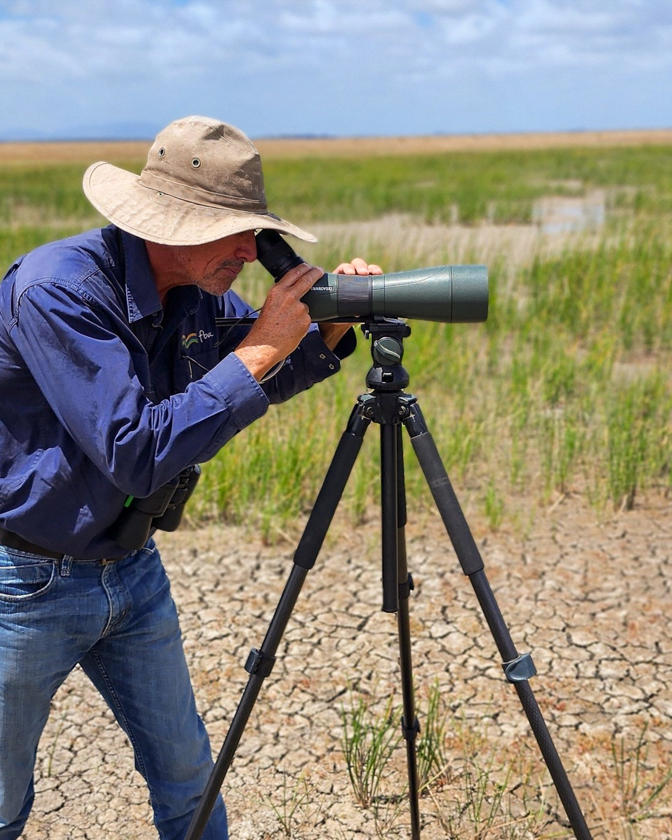 A man looking through a binocular
