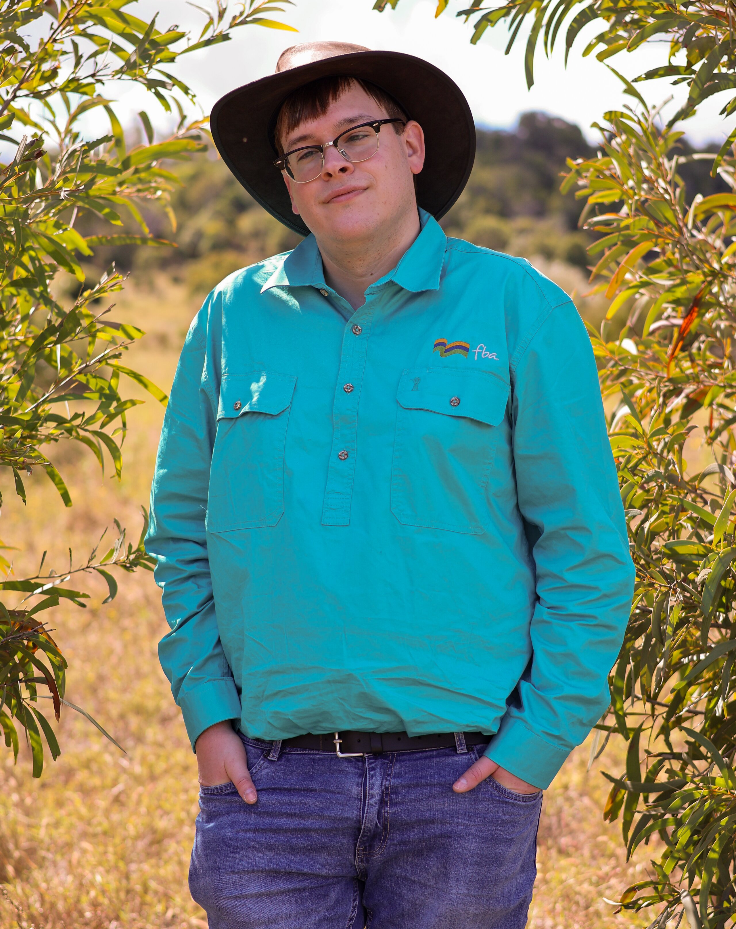 A man standing between Brigalow regrowth
