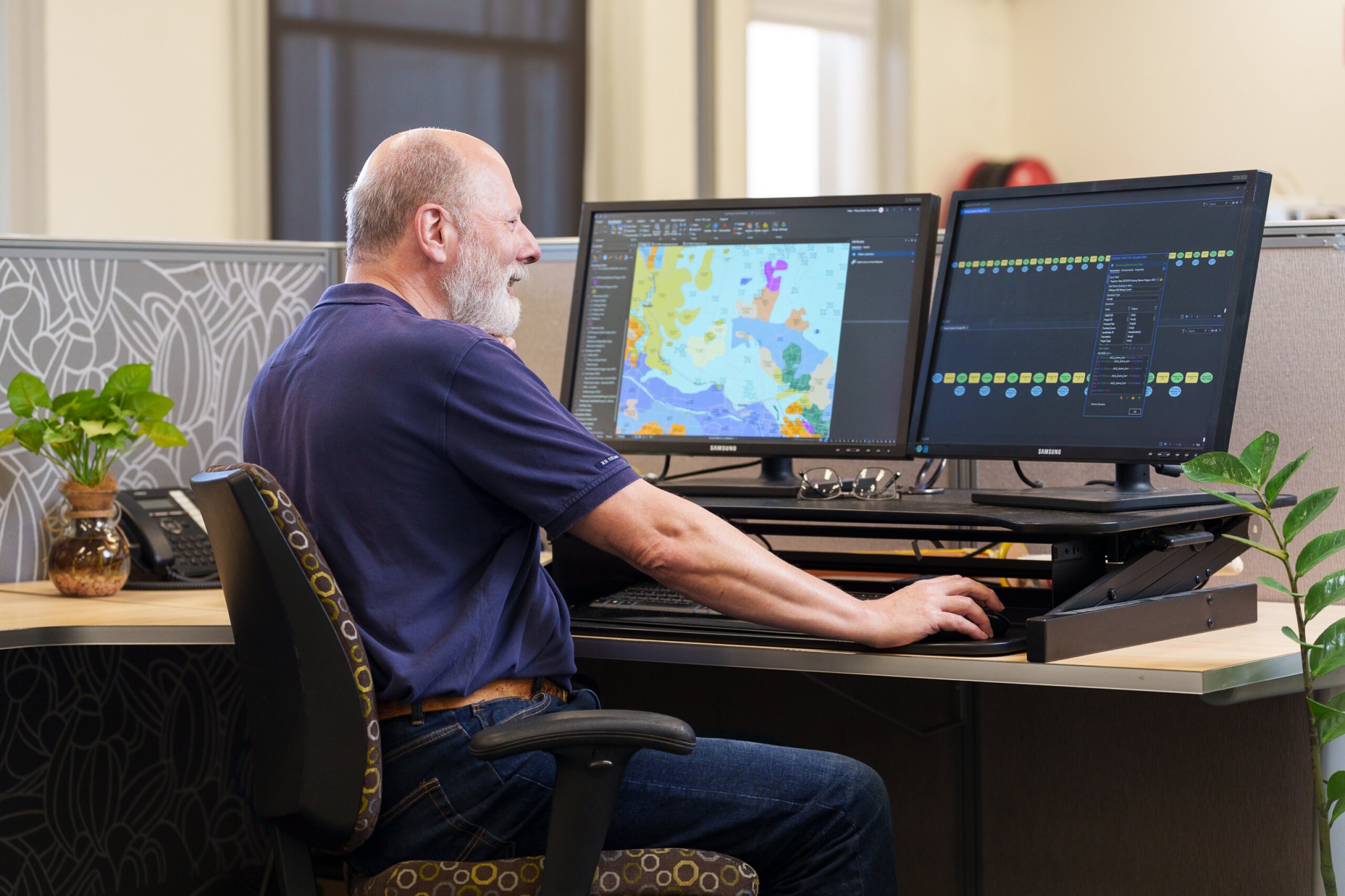 A man sitting on his desk working on mapping data