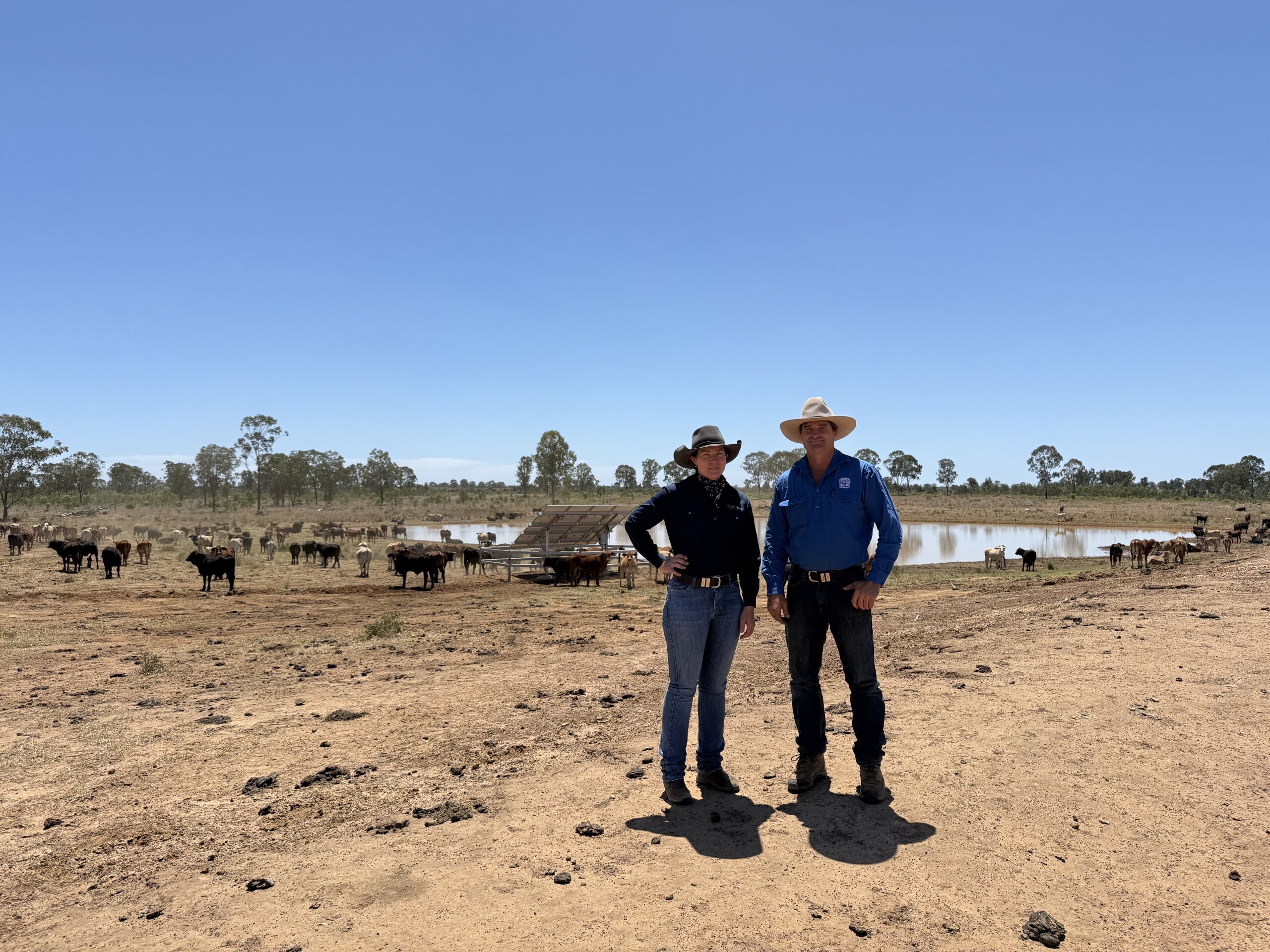 An FBA staff member and a land manager standing in a paddock