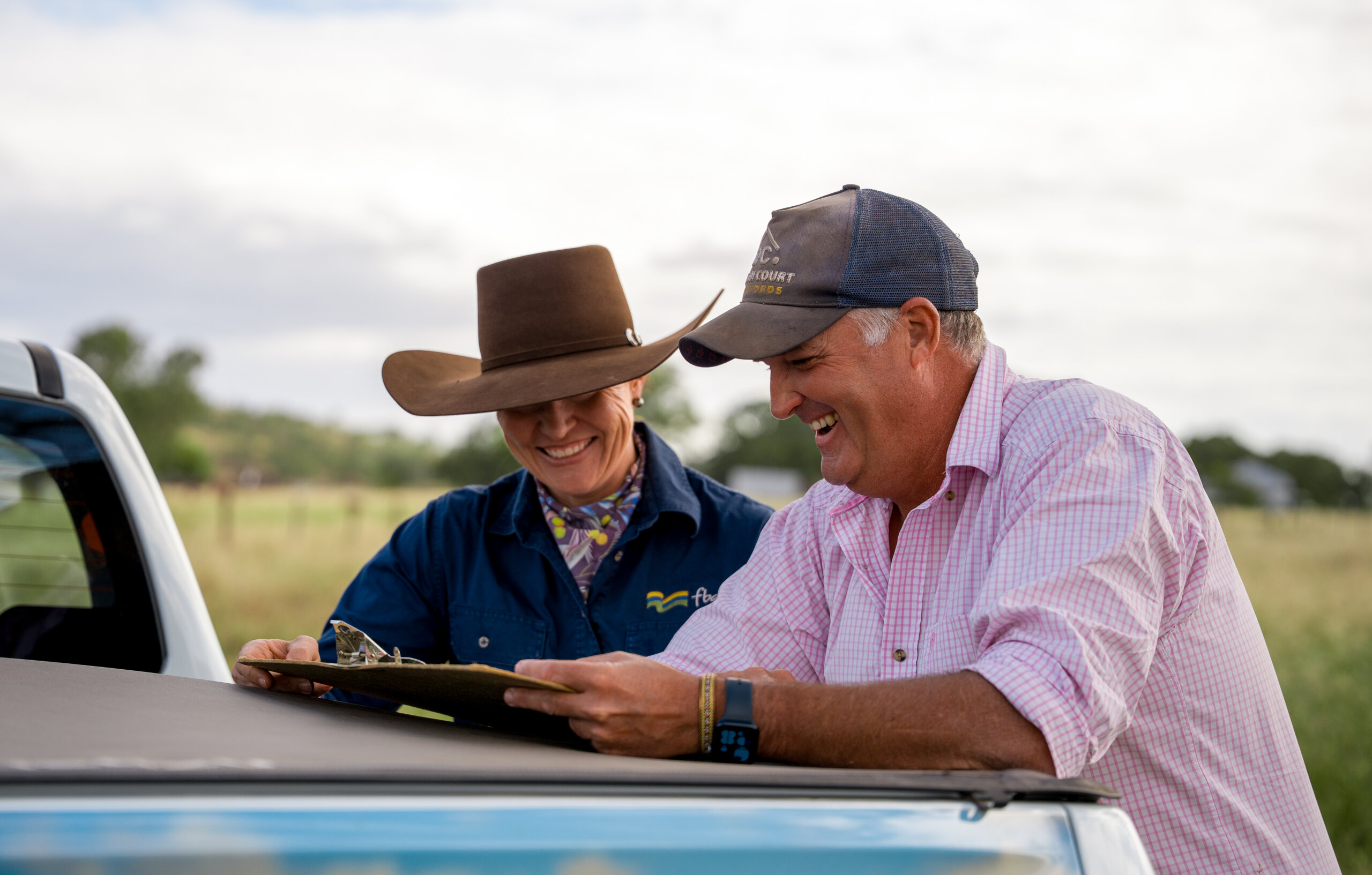 An FBA staff member looking at property maps with a land manager