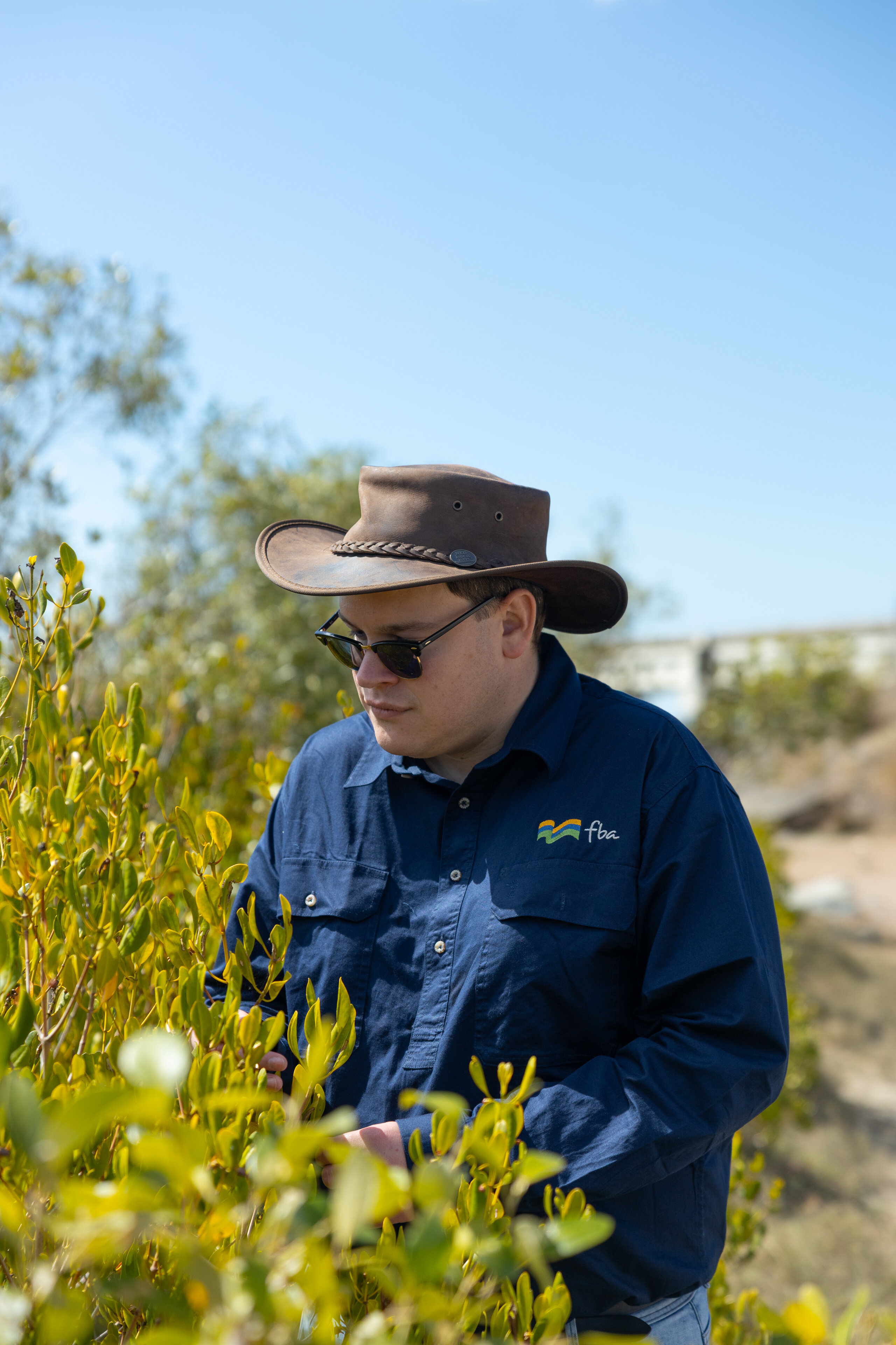 An FBA staff member inspecting plants