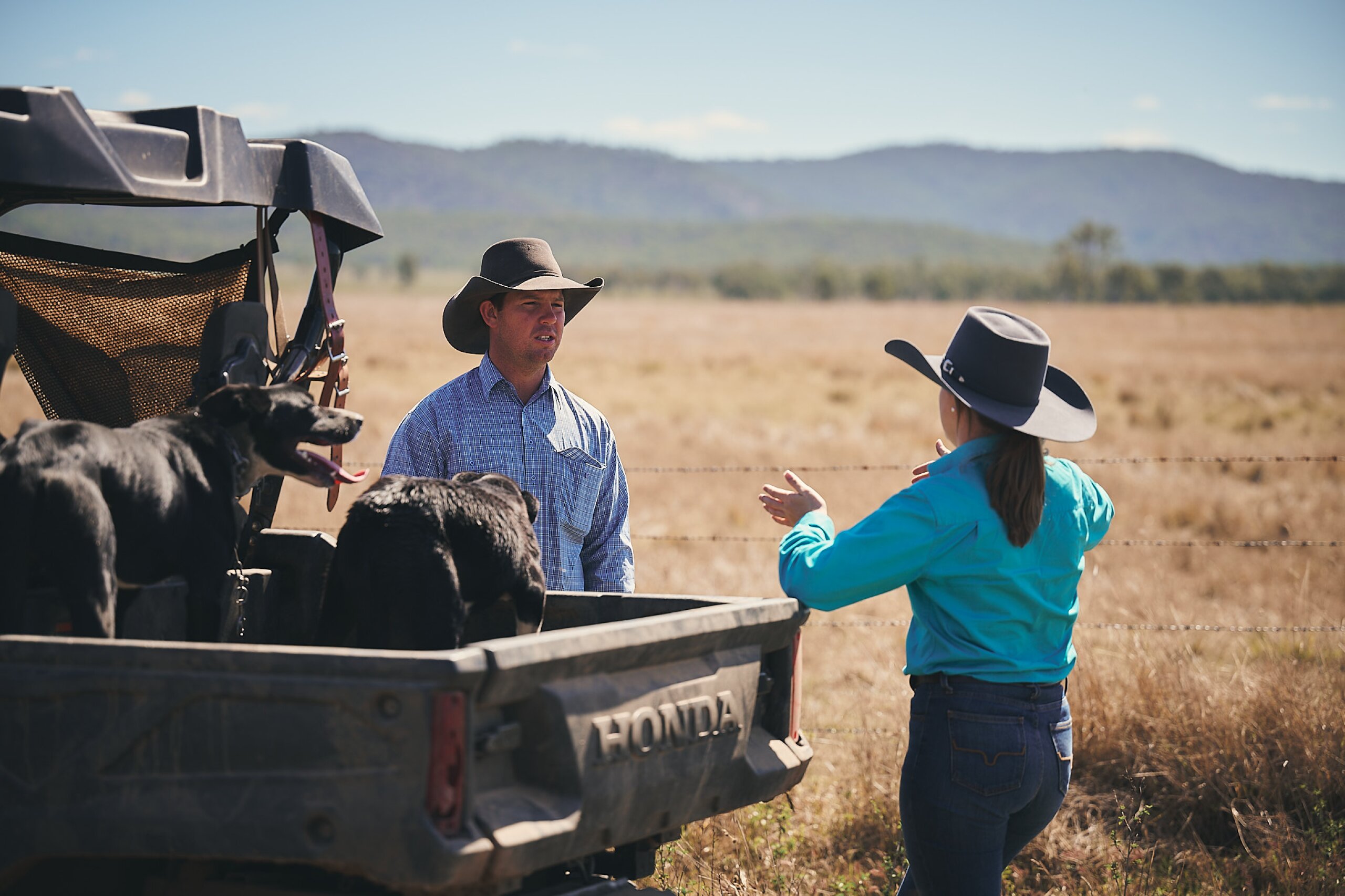 An FBA staff member and a land manager standing next to a four-wheeler talking during a property visit