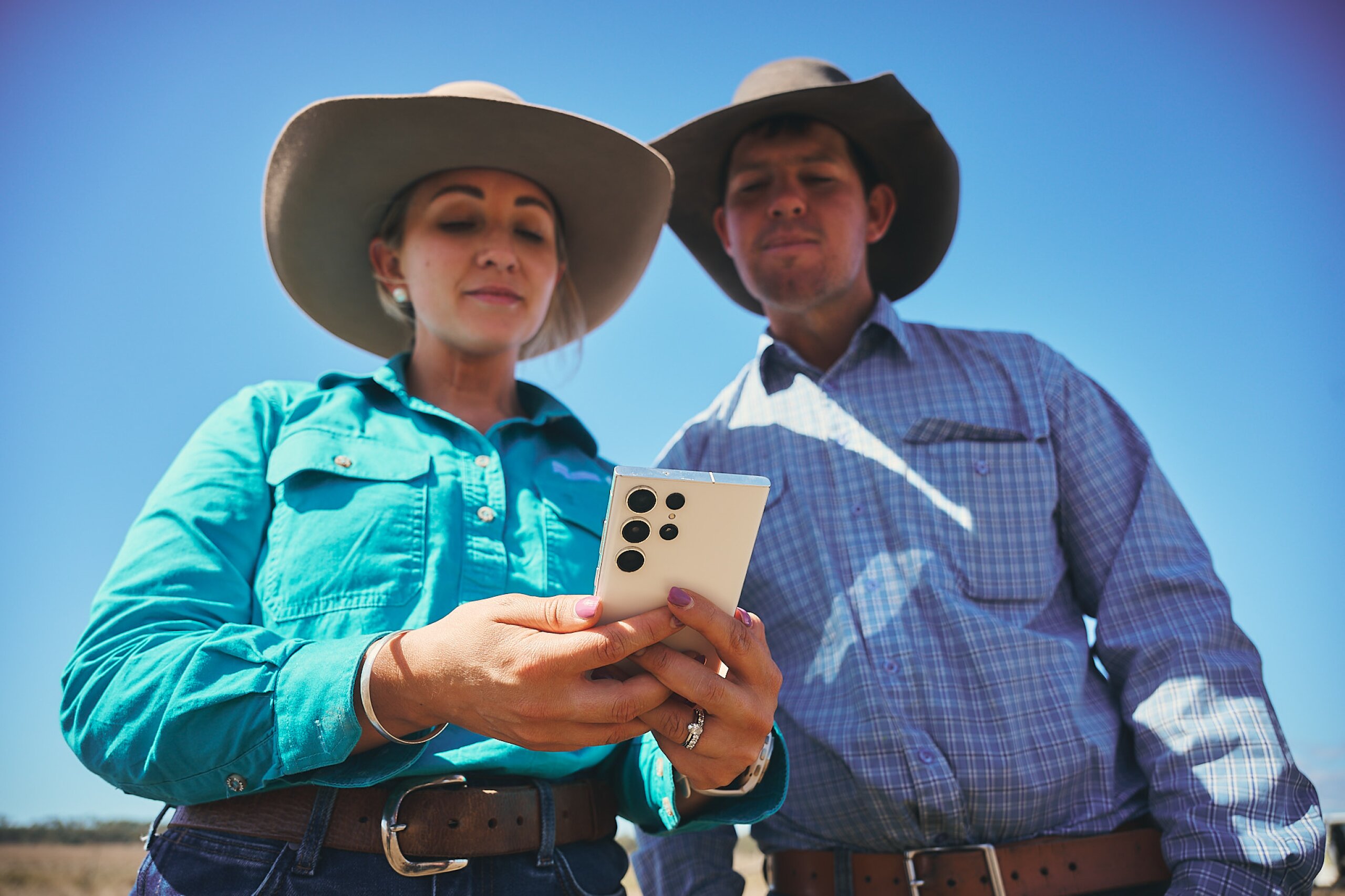 An FBA staff member looking at documents on her phone together with a land manager