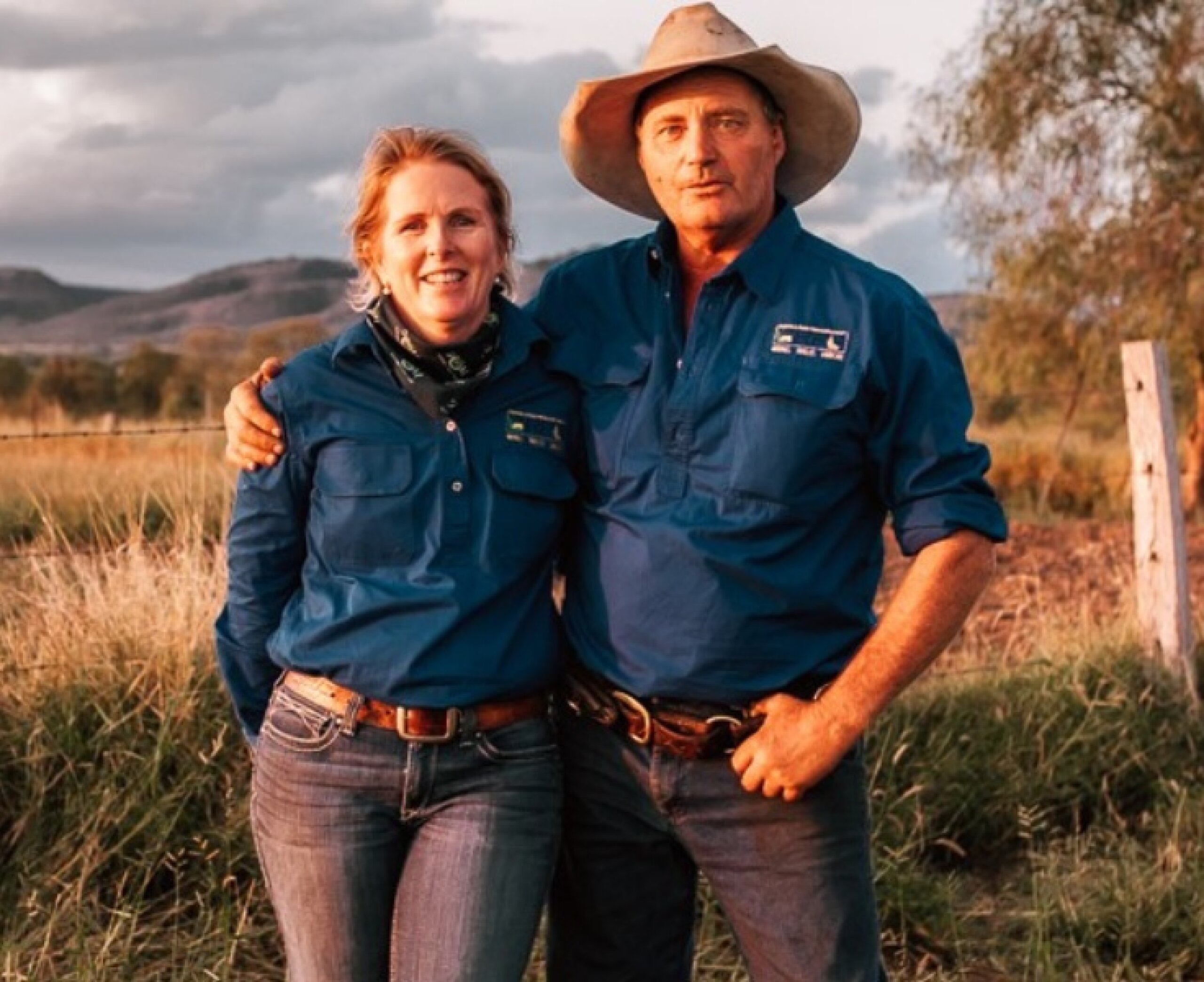 Two land managers standing in a field looking at the camera